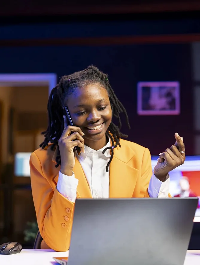 A business owner taking a customer call at their desk